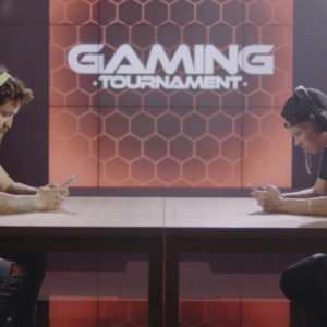 Medium shot of a man and woman competing at a mobile gaming tournament